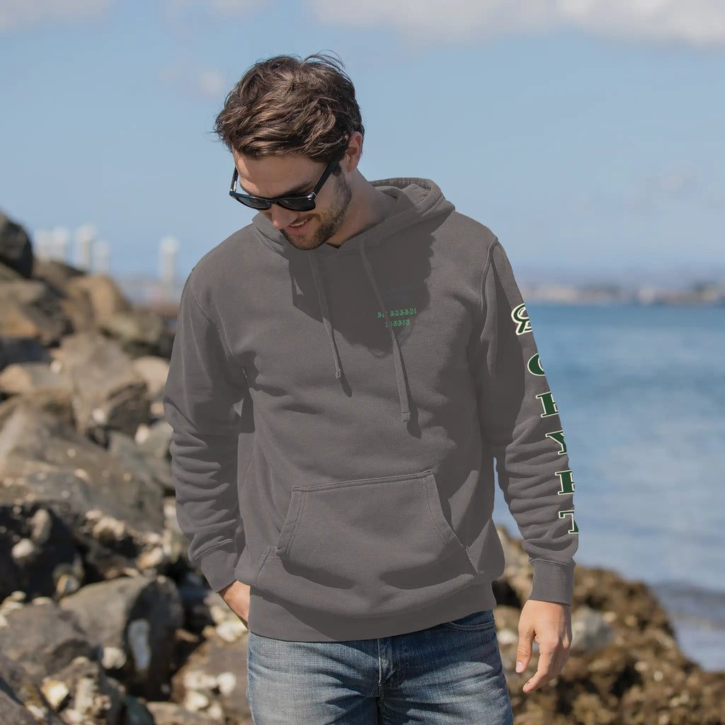 Decode the City Cipher Hoodie — Lifestyle front view, model at coastline